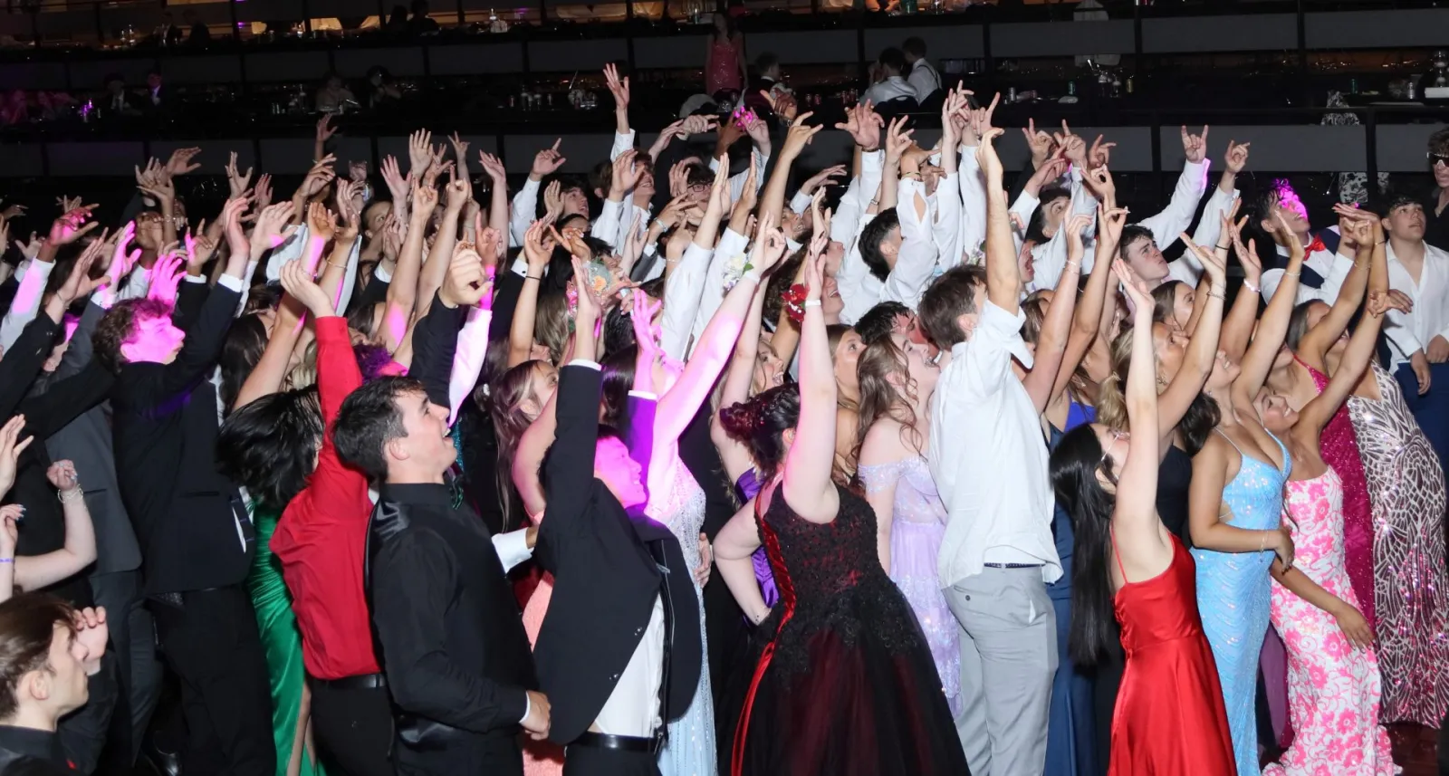 Students with hands in the air at the 2024 Shaker Junior Prom