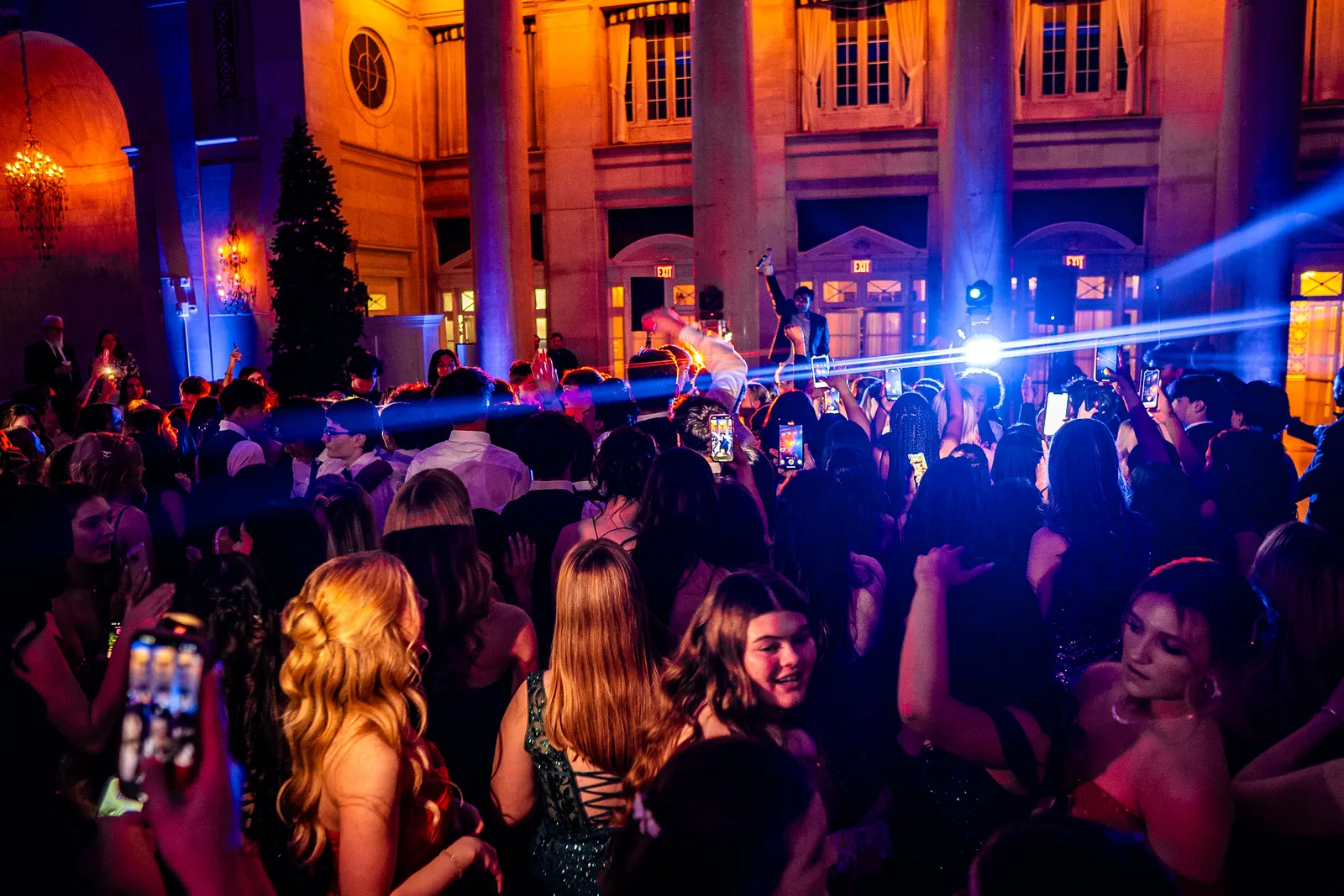 Students dancing under blue intelligent lighting at a winter formal in a historic Albany ballroom