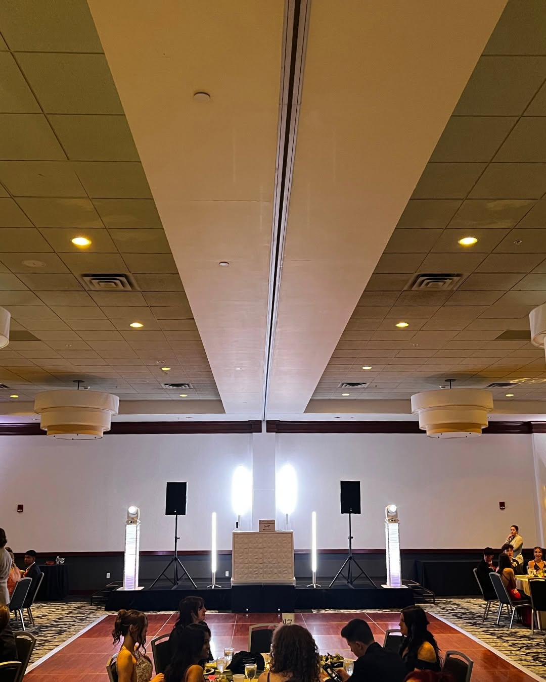 NWN Entertainment DJ stage setup with speakers and light towers at a Capital Region prom