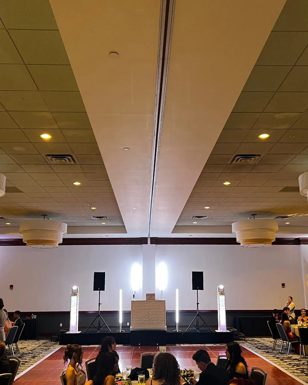 NWN Entertainment DJ stage setup with speakers and light towers at a Capital Region prom
