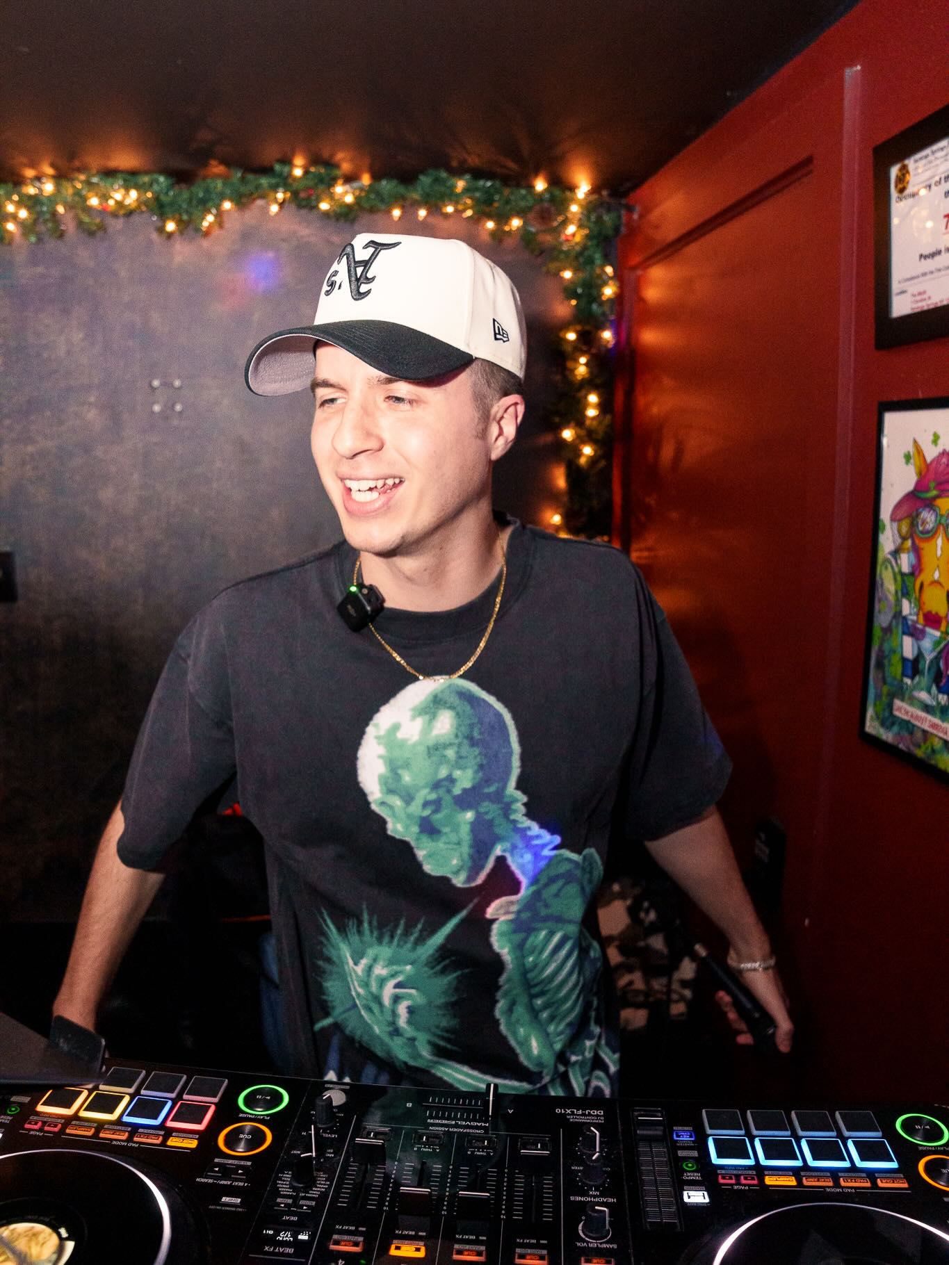 DJ Chris G smiling behind the decks at a holiday nightlife event