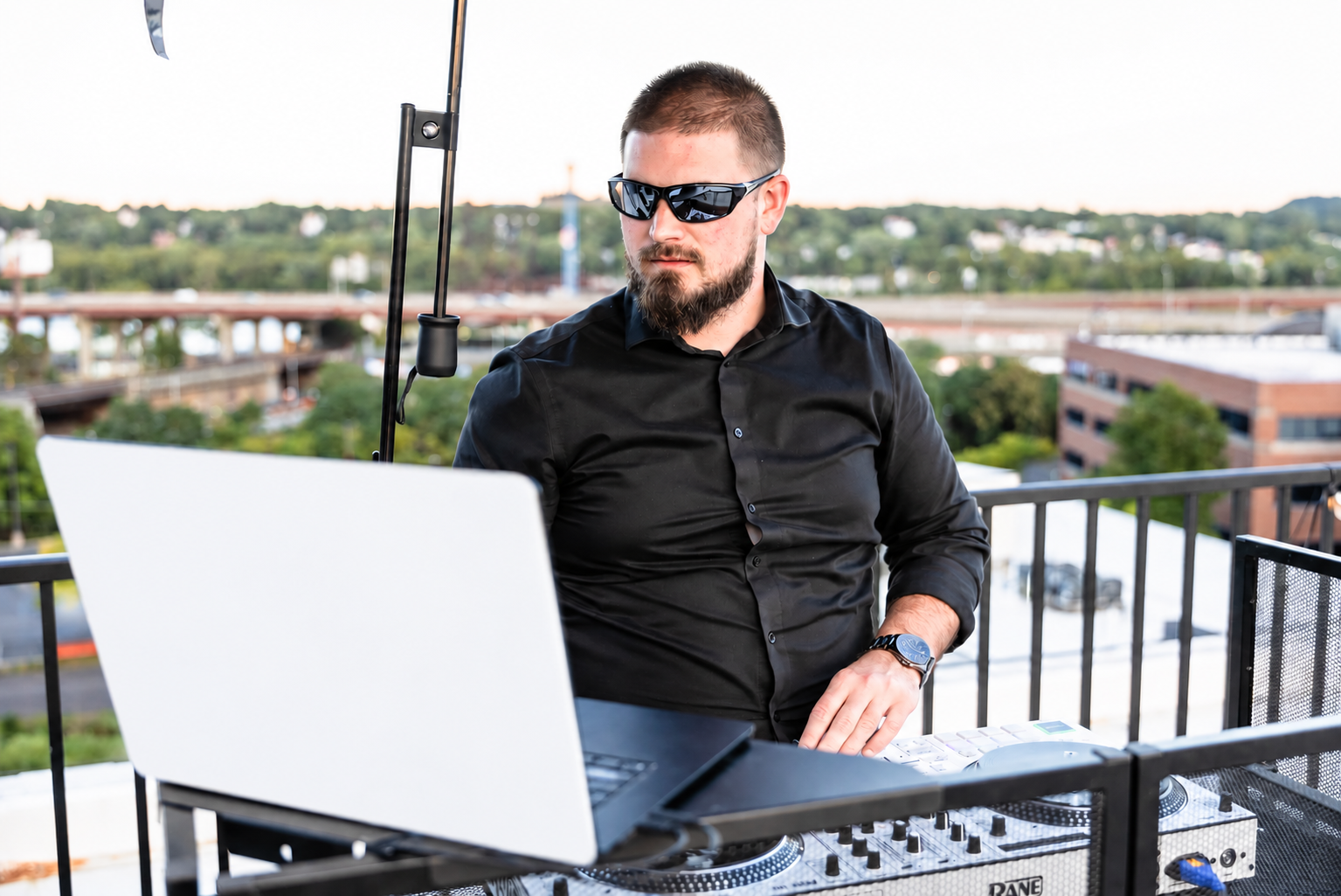 DJ Emvy Marshall VanBuren DJing a rooftop event overlooking Albany NY