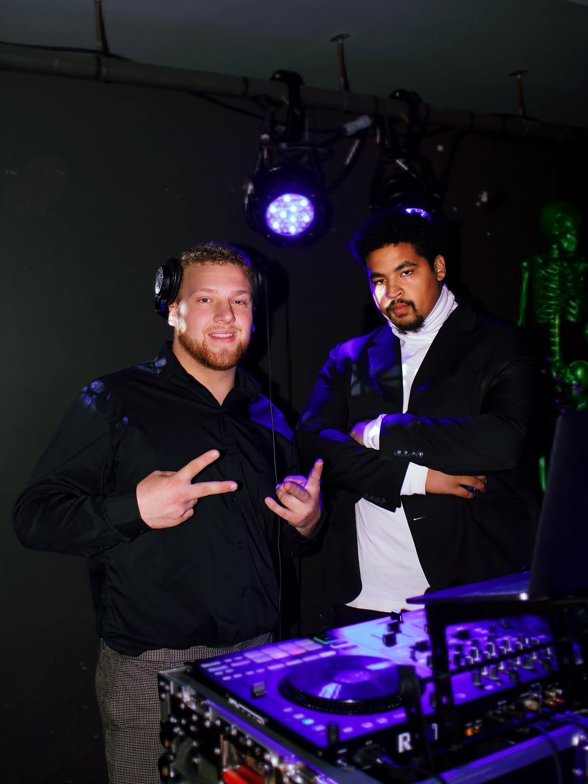 DJ Bump at his DJ booth under blue uplighting on Halloween weekend 2025