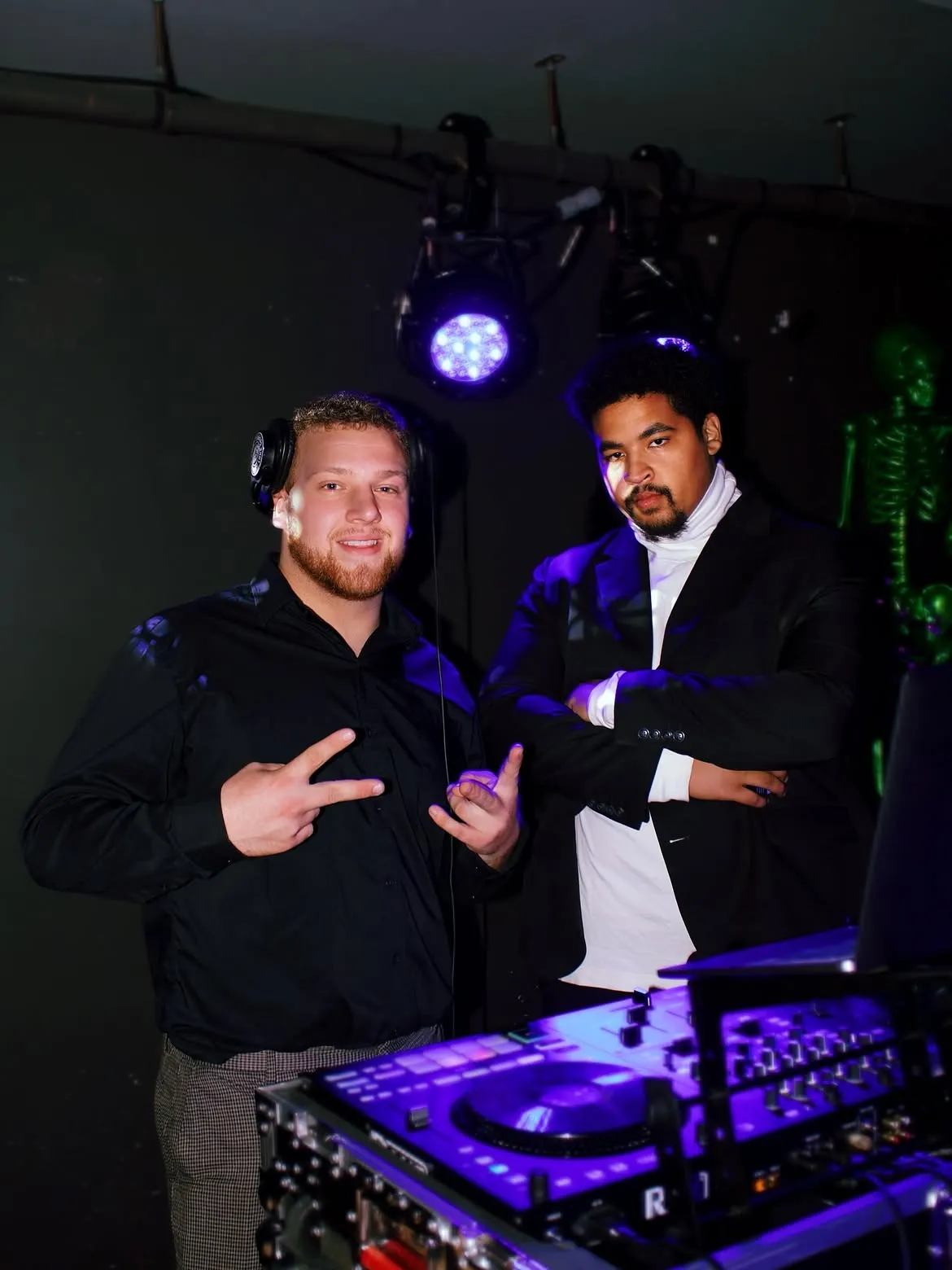 DJ Bump at his DJ booth under blue uplighting on Halloween weekend 2025