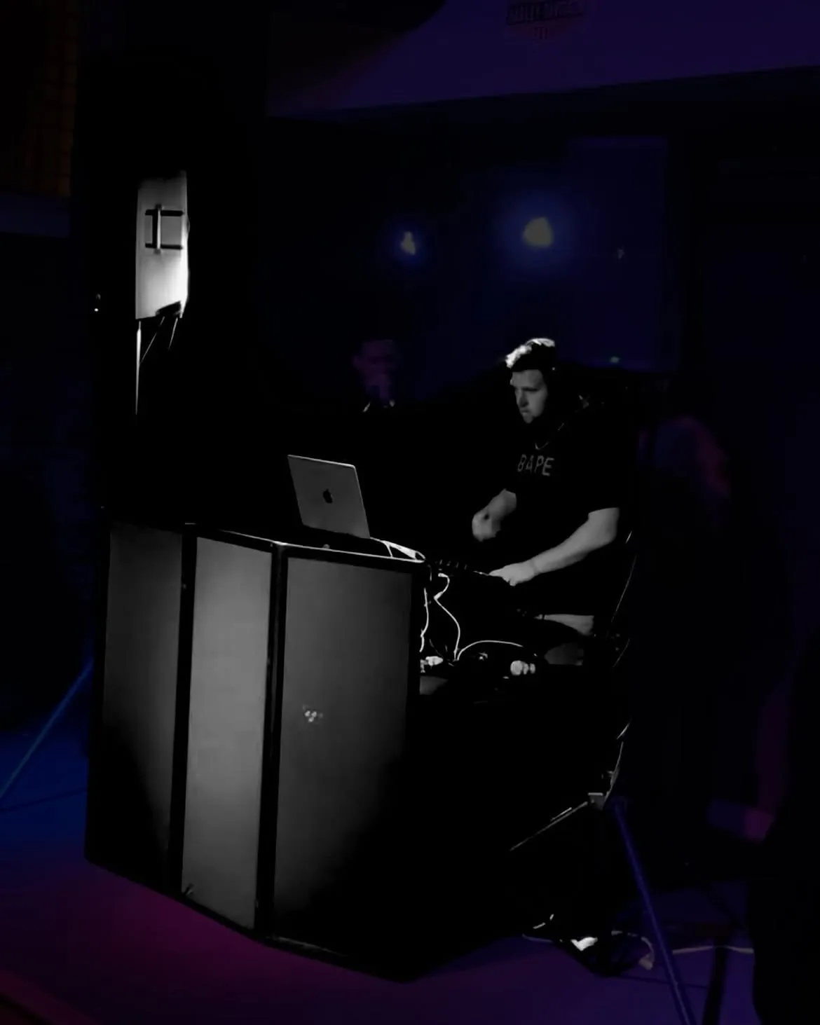 DJ Bump mixing live in the dark at a school dance